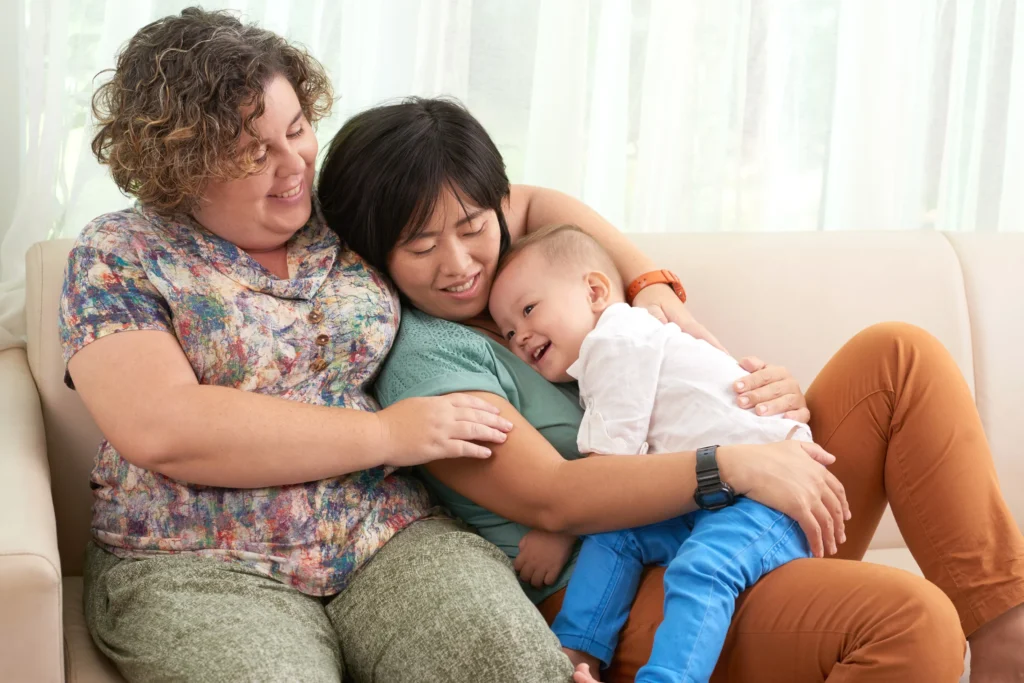 A family hugging their adopted child.