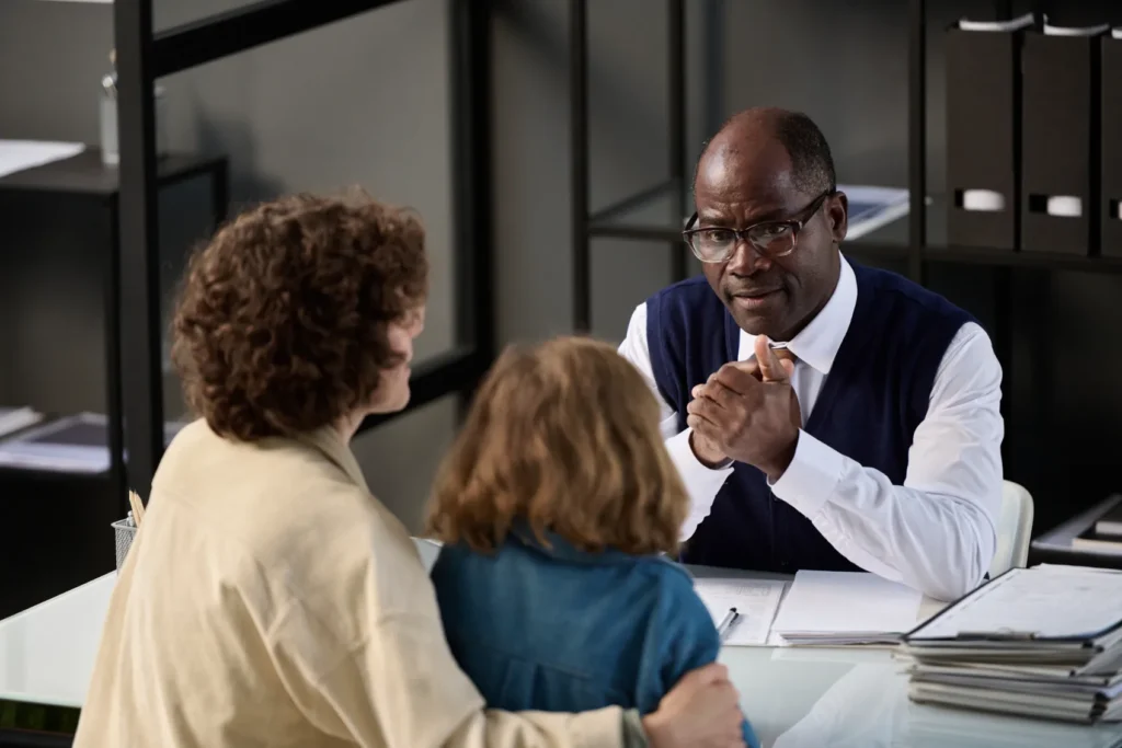 Attorney speaking with client and child.
